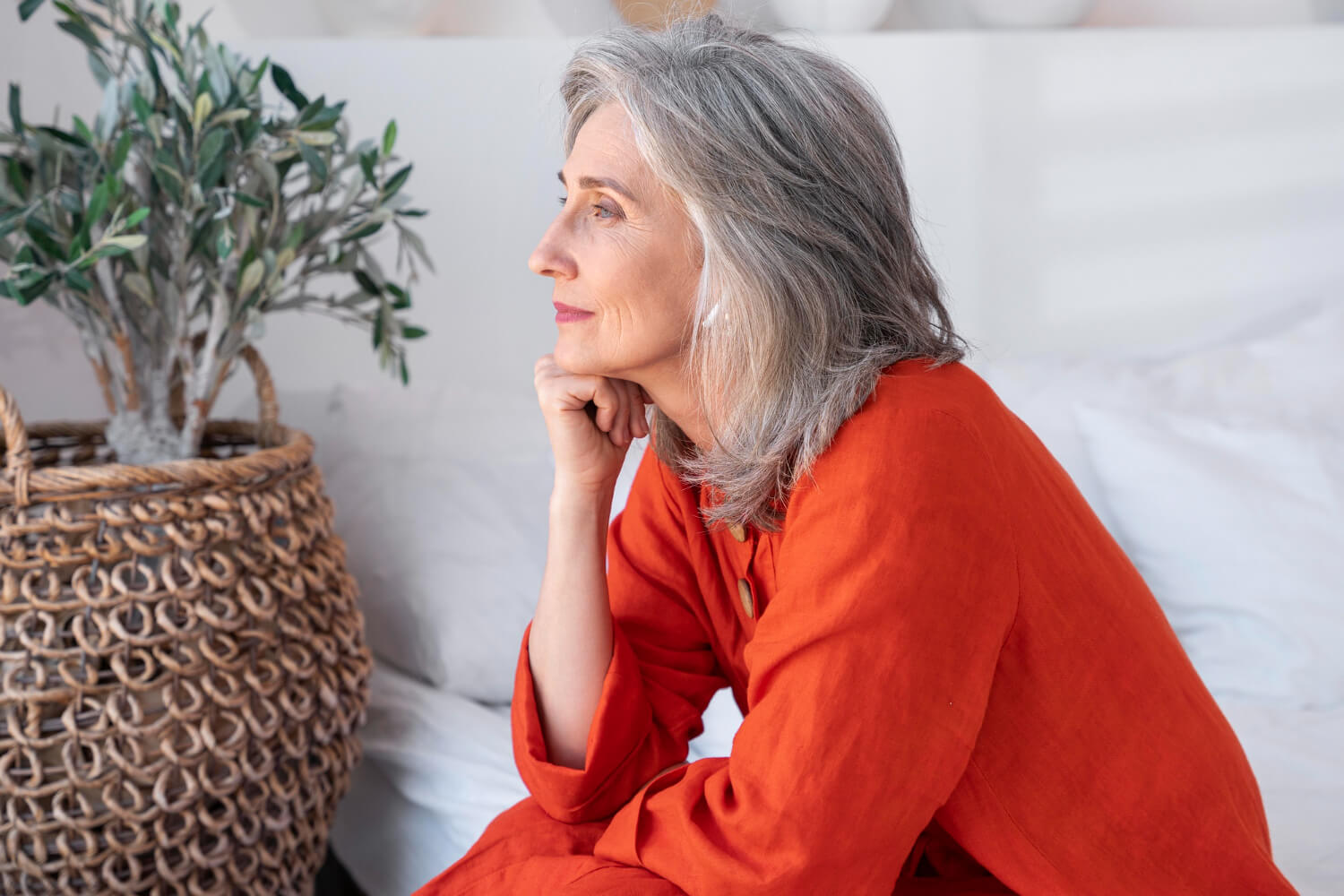 older woman widow looking out contemplatively